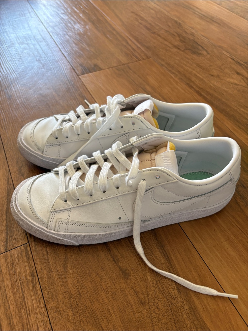 Nike White Low-Top Leather Sneakers with Subtle Yellow Tongue Accent